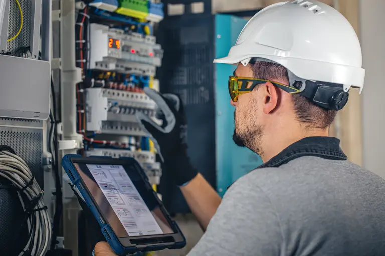 A man working on a variable frequency drive - Keltour.